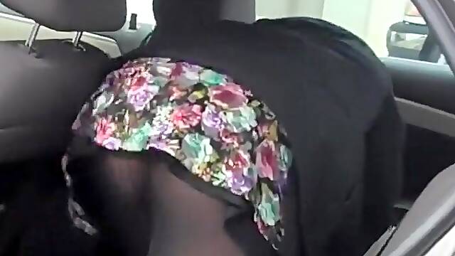 Butt covered with pantyhose in a car