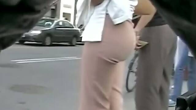 A voyeur following a perfect ass in tight pants on the street
