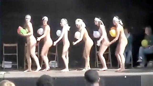 Naked ladies dance on stage with balloons