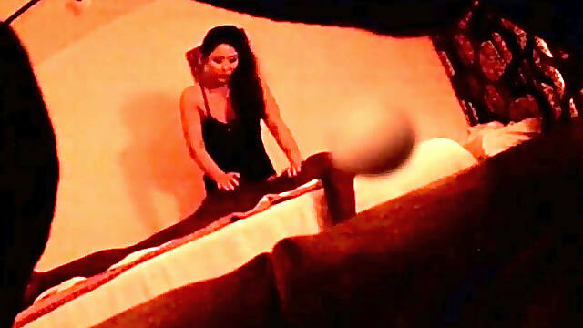 Stunning Oriental masseuse works her hands on a black pole