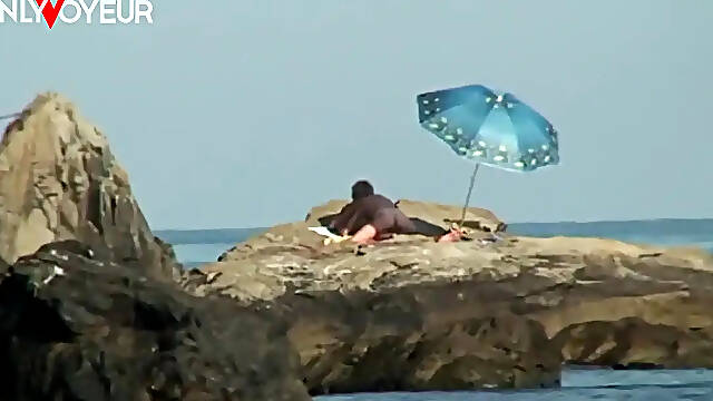 Tanned MILF wife fucks husband in cowgirl on beach