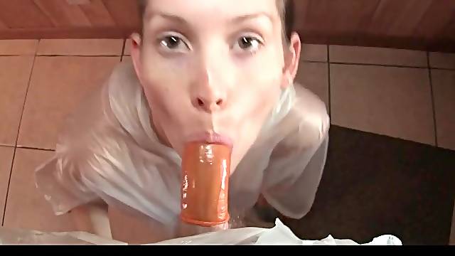 Rubber poncho on Lelu Love sucking condom cock
