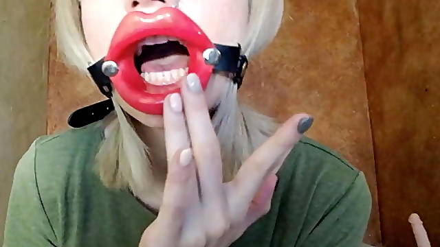 Zooming in red lips open mouth gag for dildo-blowjob.