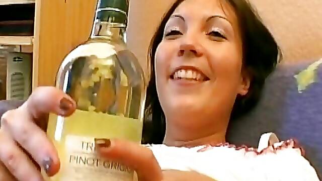 Hot German girl with big tits stuffing a bottle in her shaved pussy