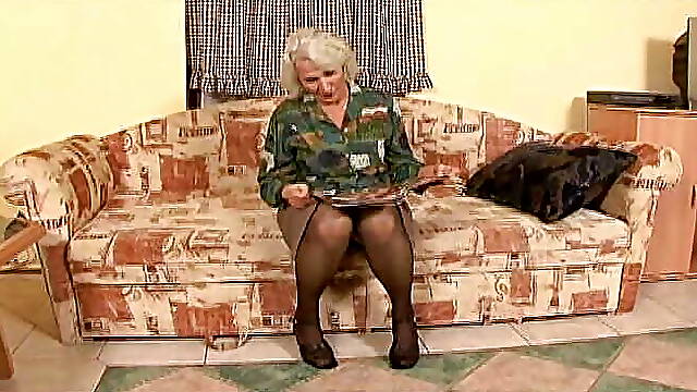 Granny has fun with her thick dildo